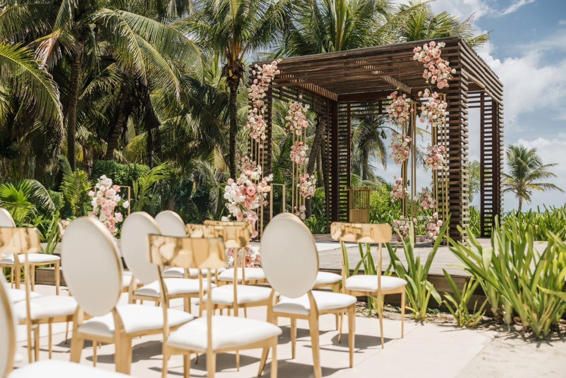 Tropical destination wedding ceremony venue with floral decor